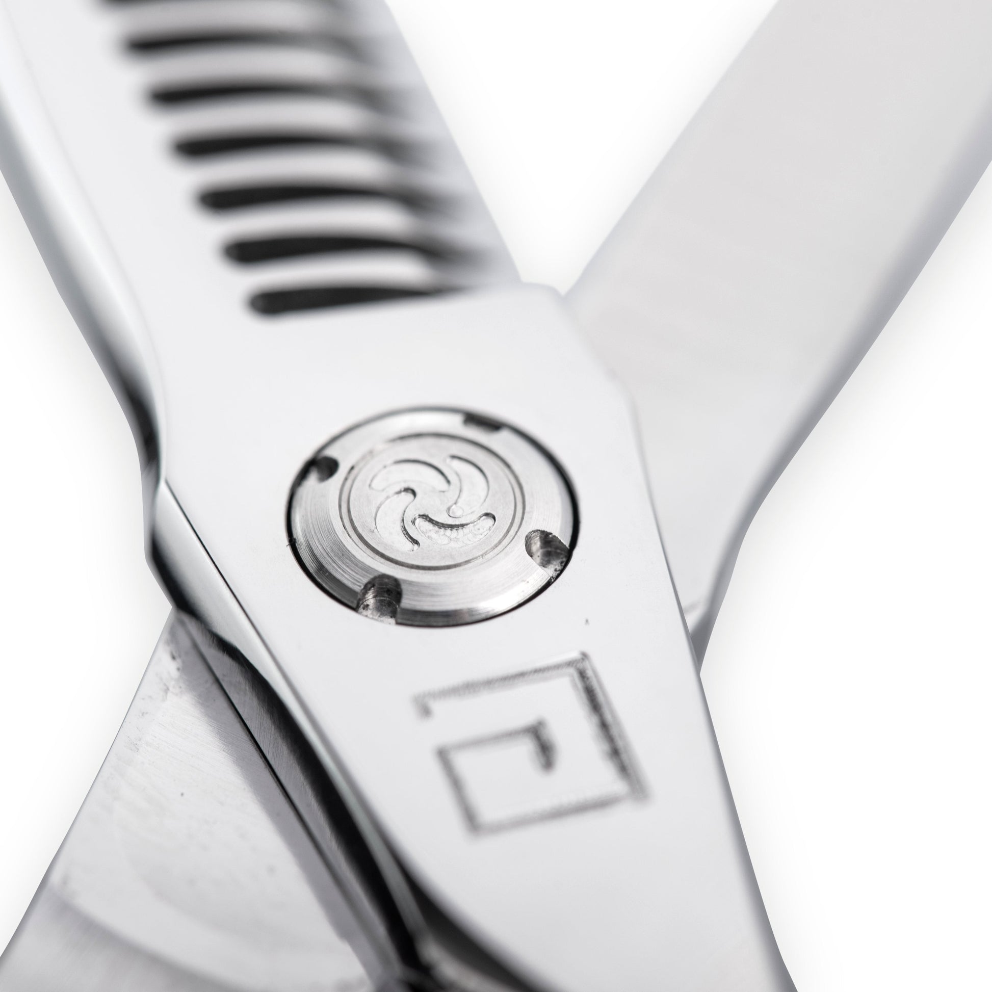 Macro close-up of precision pivot and tension adjustment on InfynitEdge professional shear